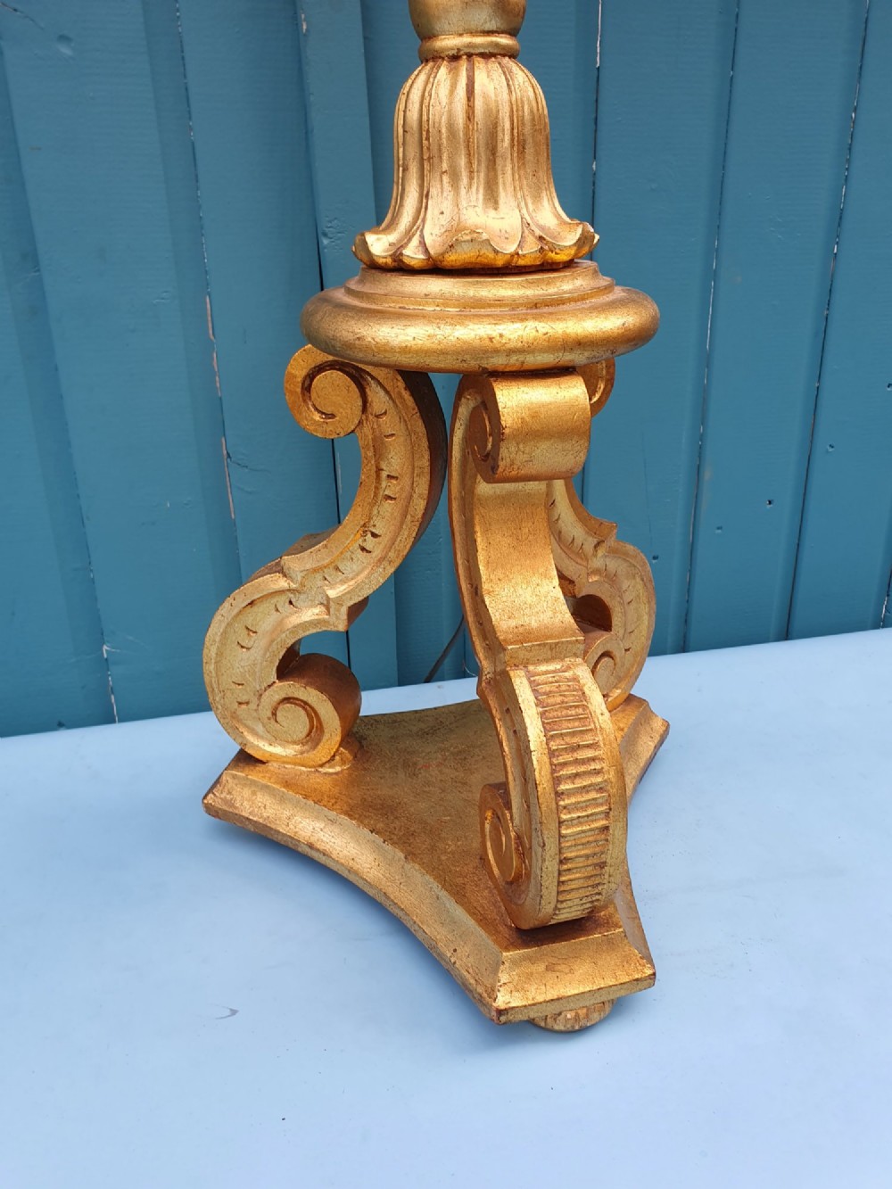 A late nineteenth-century carved giltwood standard lamp featuring a fluted column, ornamental knops, and a scroll-carved tripod base. View IX