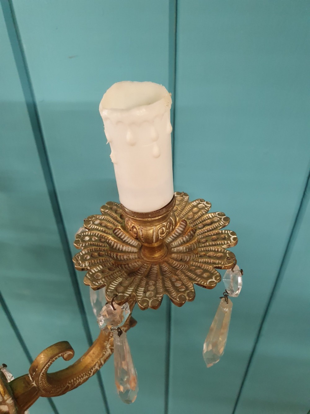 A six-arm brass tent chandelier decorated with crystal beads, drop pendants, and a leaf corona at the top. View VII