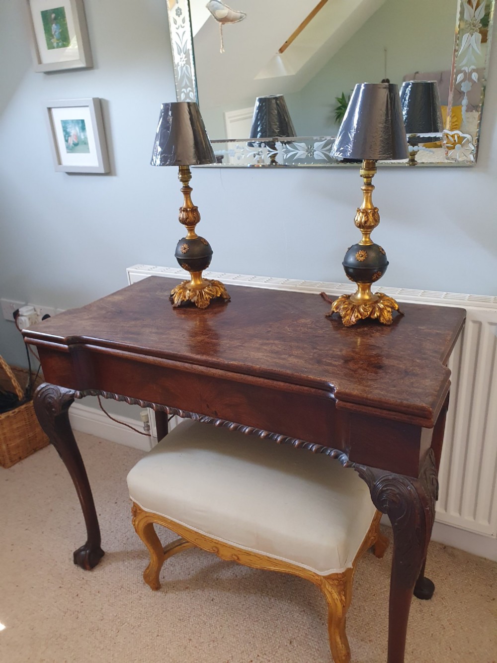 A pair of early 20th-century gilt brass table lamps featuring flared acanthus leaf bases, dark spherical central sections with gold floral mounts, and turned upper columns. View VII