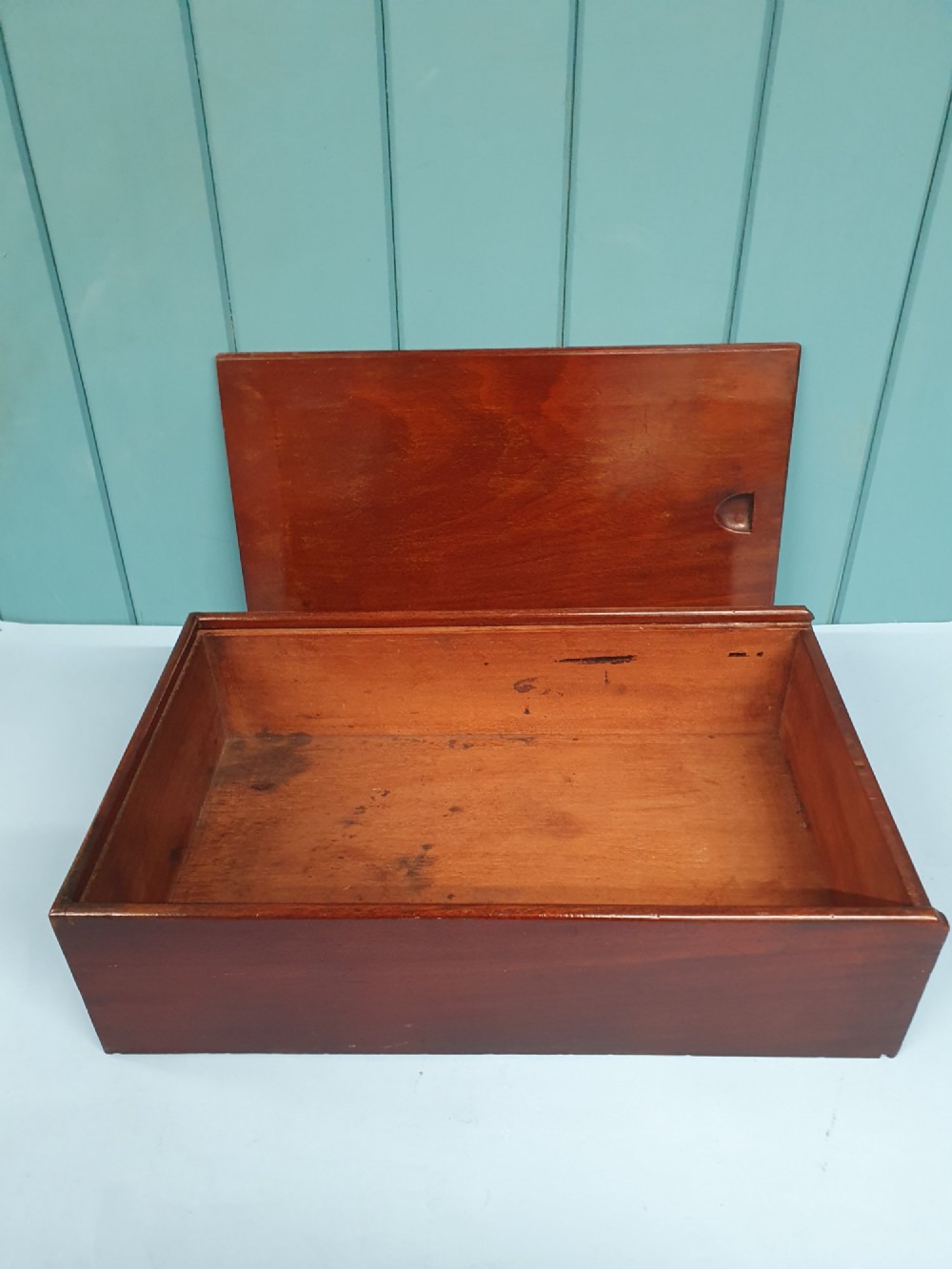 A rectangular Georgian mahogany document box featuring a sliding lid mechanism and warm brown wood grain finish. View V