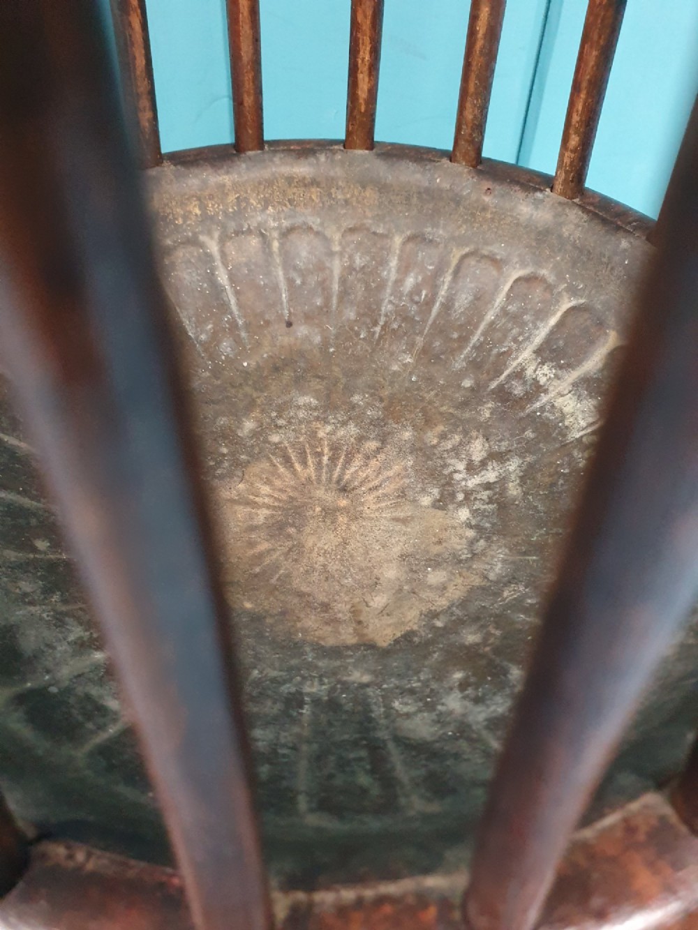 An early 20th-century oak stick stand featuring a flared, circular slatted framework tapering at the centre with an integrated metal drip tray at the circular base. View III