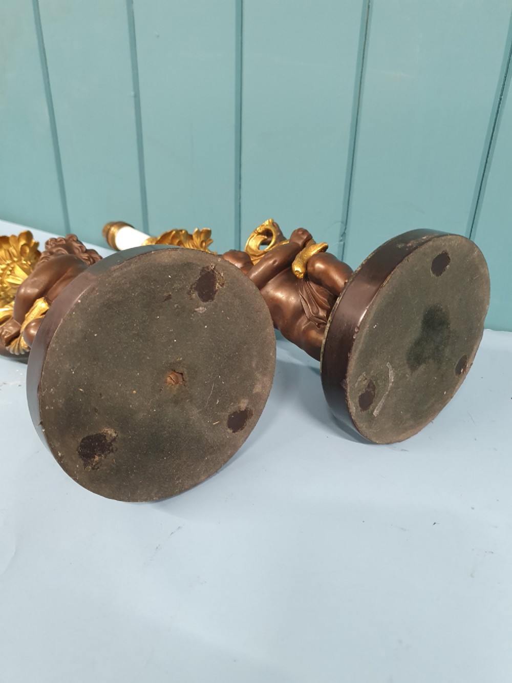 A pair of 1920s French-style dark bronze cherub table lamps with gilt foliate stems set on round black marble bases. View II