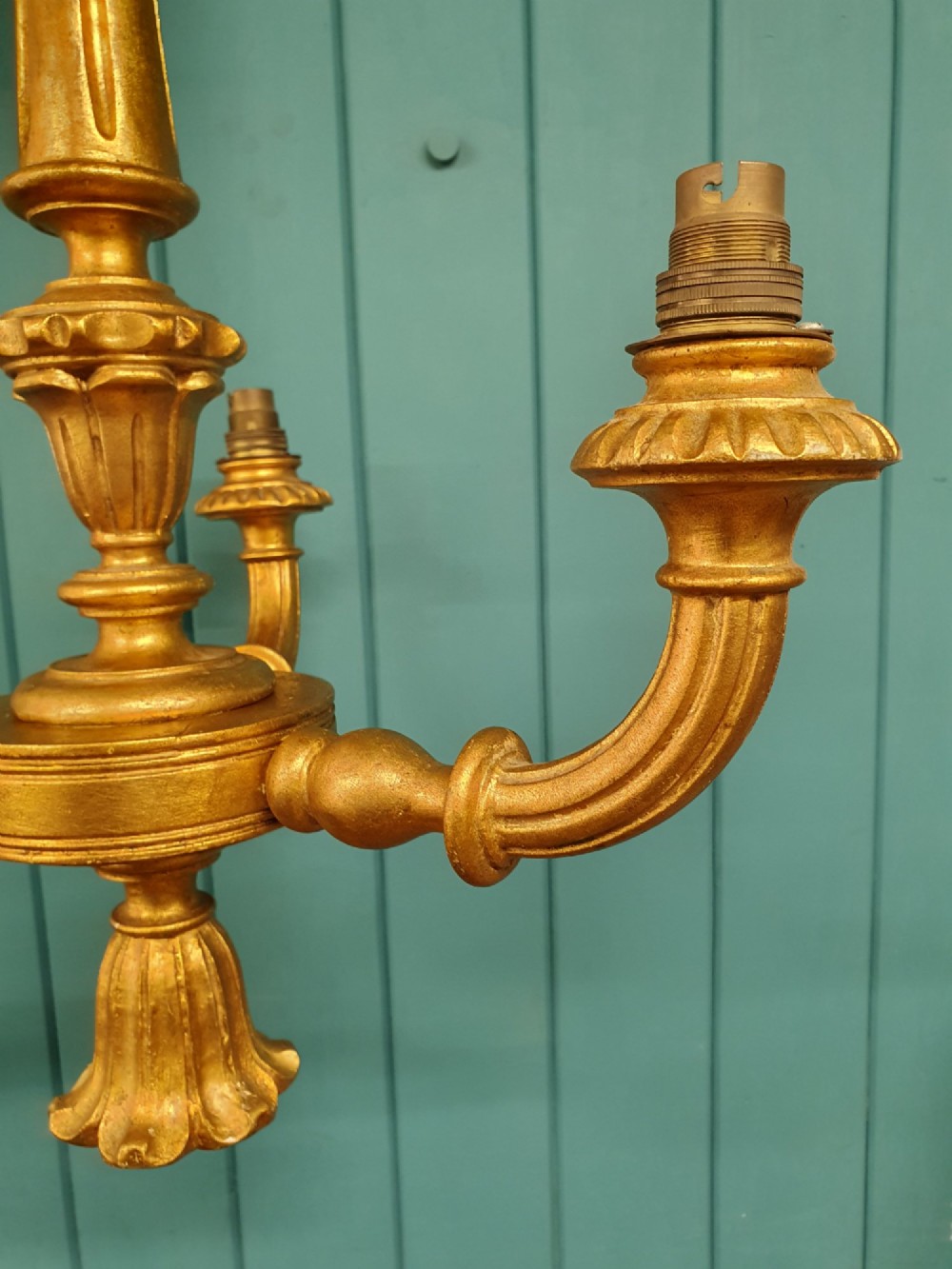 Circa 1900 carved giltwood three-arm chandelier featuring a central turned column, scrolled branches, fluted bottom drop, and three purple fabric lampshades. View III
