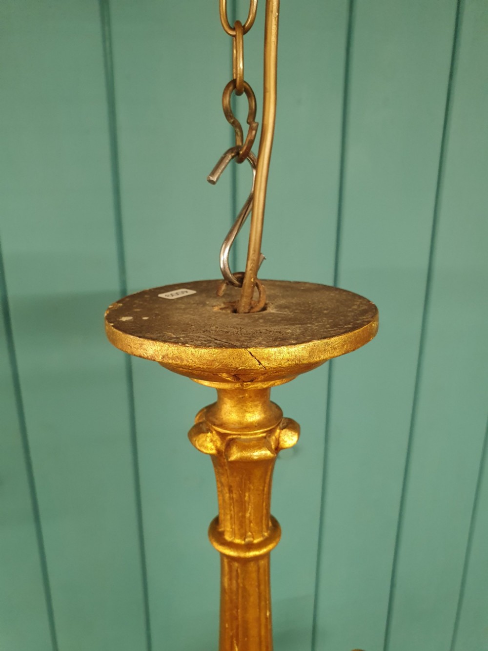 Circa 1900 carved giltwood three-arm chandelier featuring a central turned column, scrolled branches, fluted bottom drop, and three purple fabric lampshades. View V