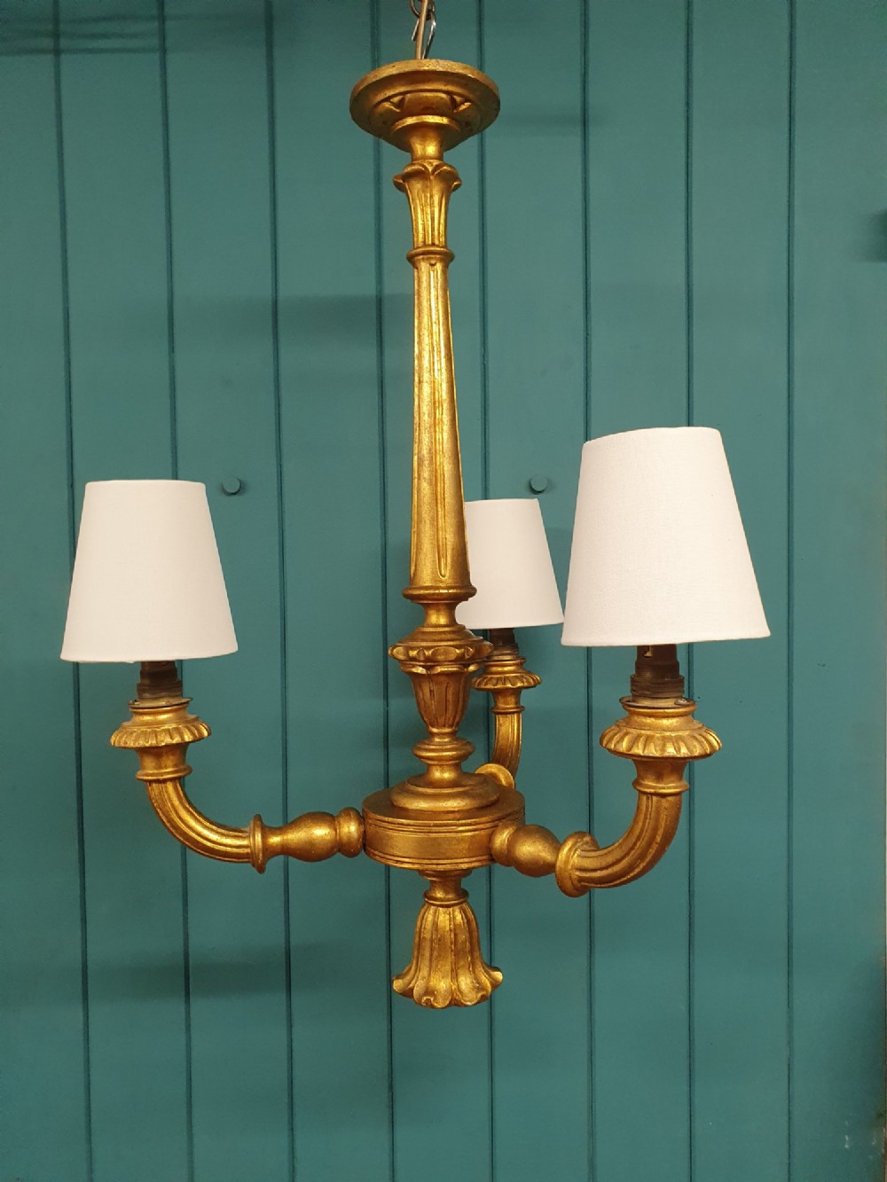 Circa 1900 carved giltwood three-arm chandelier featuring a central turned column, scrolled branches, fluted bottom drop, and three purple fabric lampshades. View VII