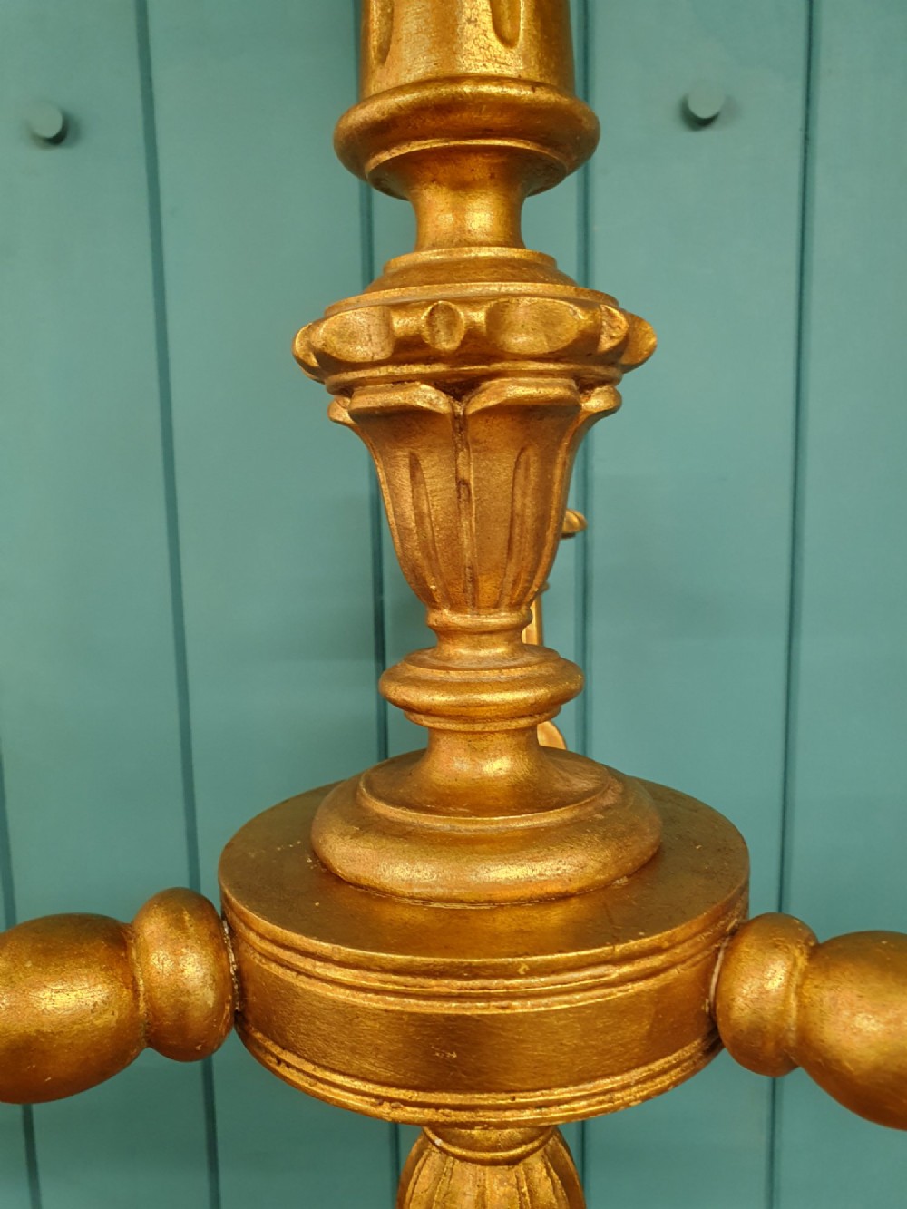 Circa 1900 carved giltwood three-arm chandelier featuring a central turned column, scrolled branches, fluted bottom drop, and three purple fabric lampshades. View VIII