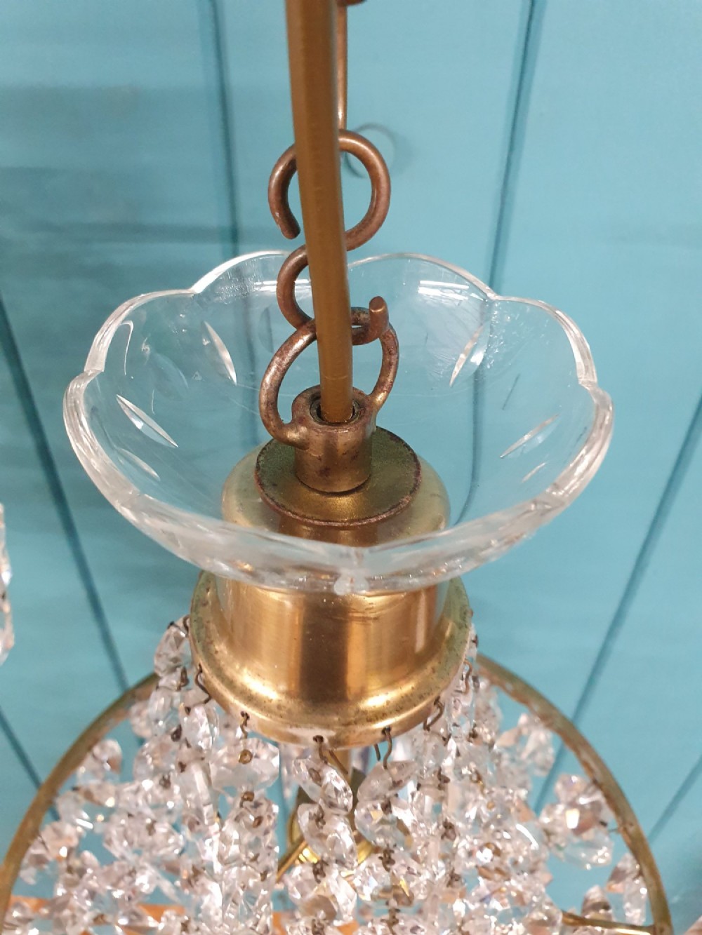 A pair of early 20th-century tent-style chandeliers featuring tier upon tier of faceted cut glass crystal beads and brass fittings. View IV