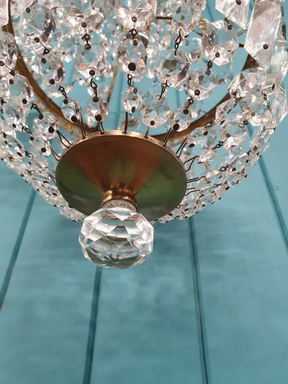A pair of early 20th-century tent-style chandeliers featuring tier upon tier of faceted cut glass crystal beads and brass fittings. View V