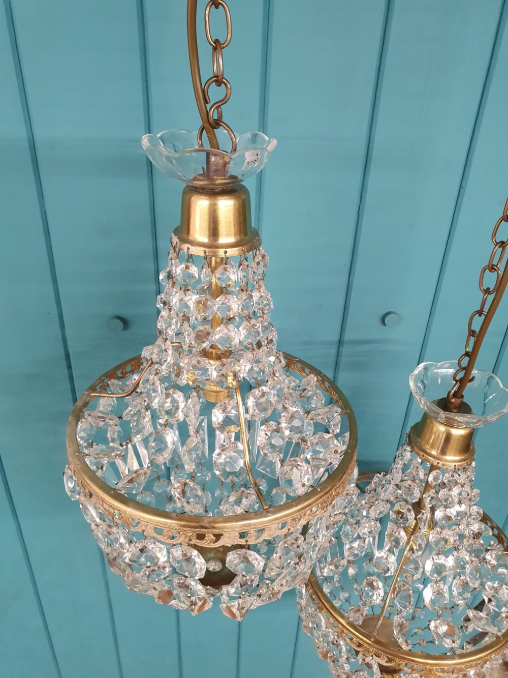 A pair of early 20th-century tent-style chandeliers featuring tier upon tier of faceted cut glass crystal beads and brass fittings. View VI