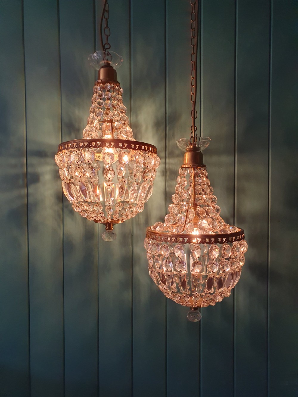 A pair of early 20th-century tent-style chandeliers featuring tier upon tier of faceted cut glass crystal beads and brass fittings. View VII