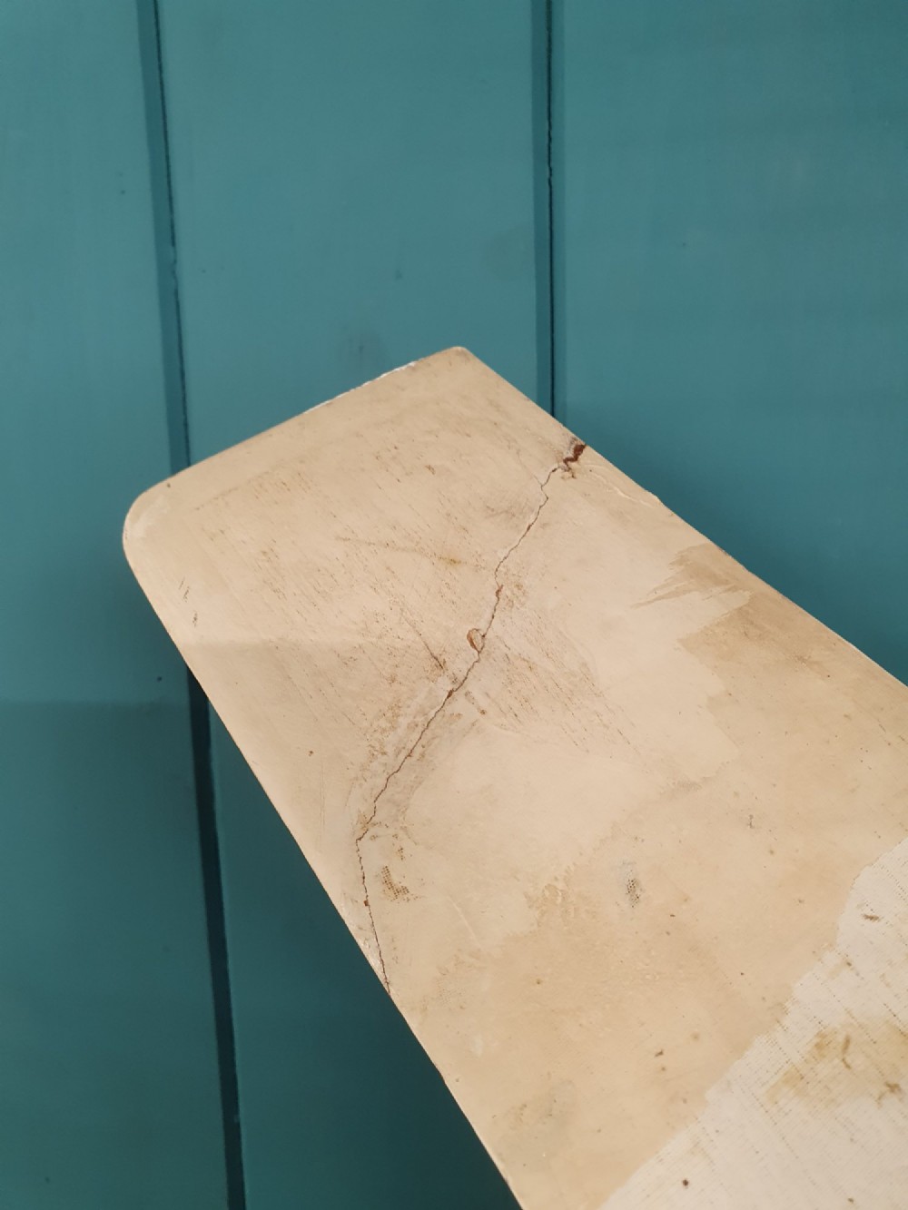 A mid-century hand-painted balsa wood control-line model aeroplane finished in green and cream with number seven painted on the fuselage. View VIII