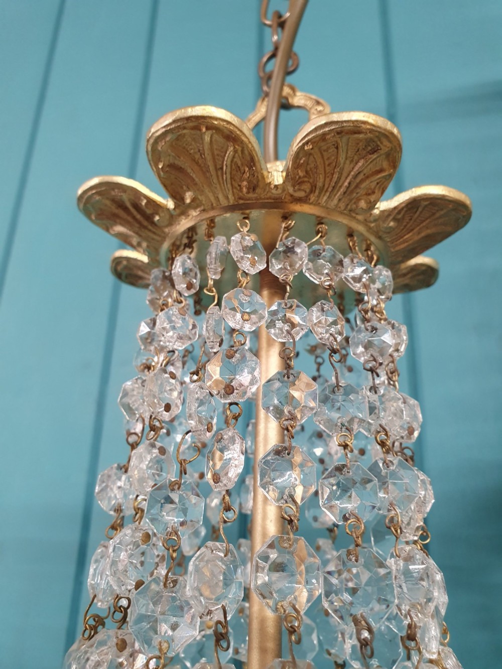 A pair of early 20th-century cut glass and brass tent chandeliers featuring tapered crystal bead strands and a lower band of rectangular faceted prisms. View IV