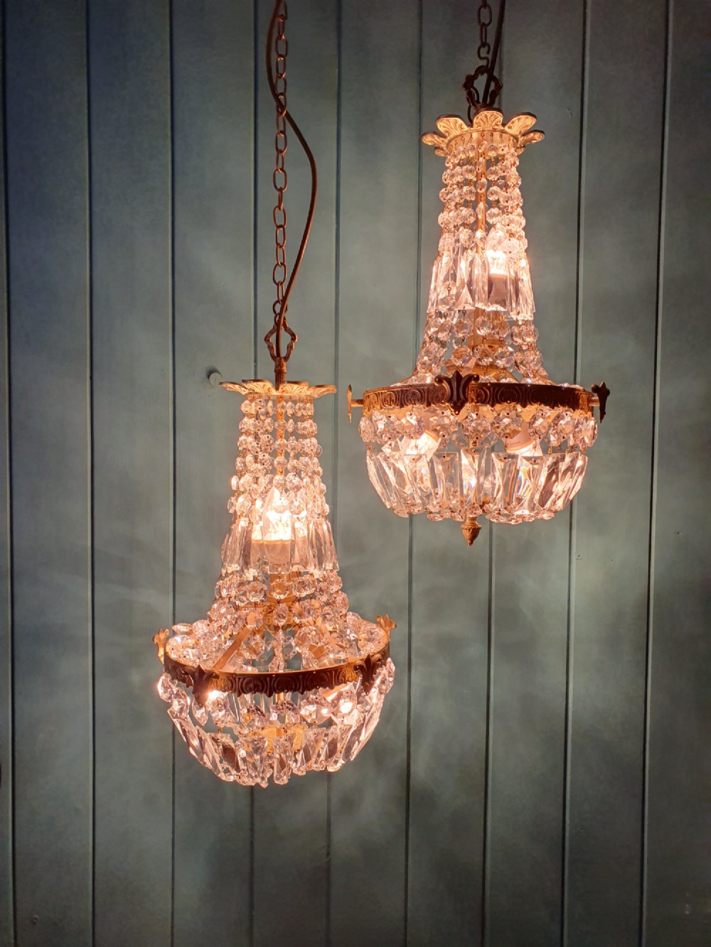 A pair of early 20th-century cut glass and brass tent chandeliers featuring tapered crystal bead strands and a lower band of rectangular faceted prisms. View VII