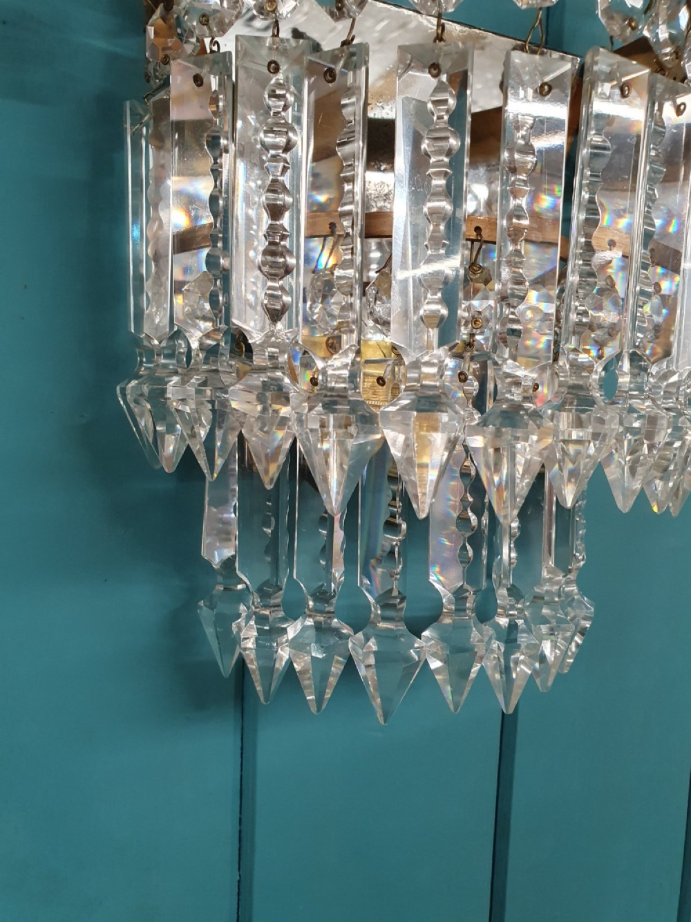 A pair of antique gilt brass wall lights with cascading tiers of cut glass crystal prisms. View IV