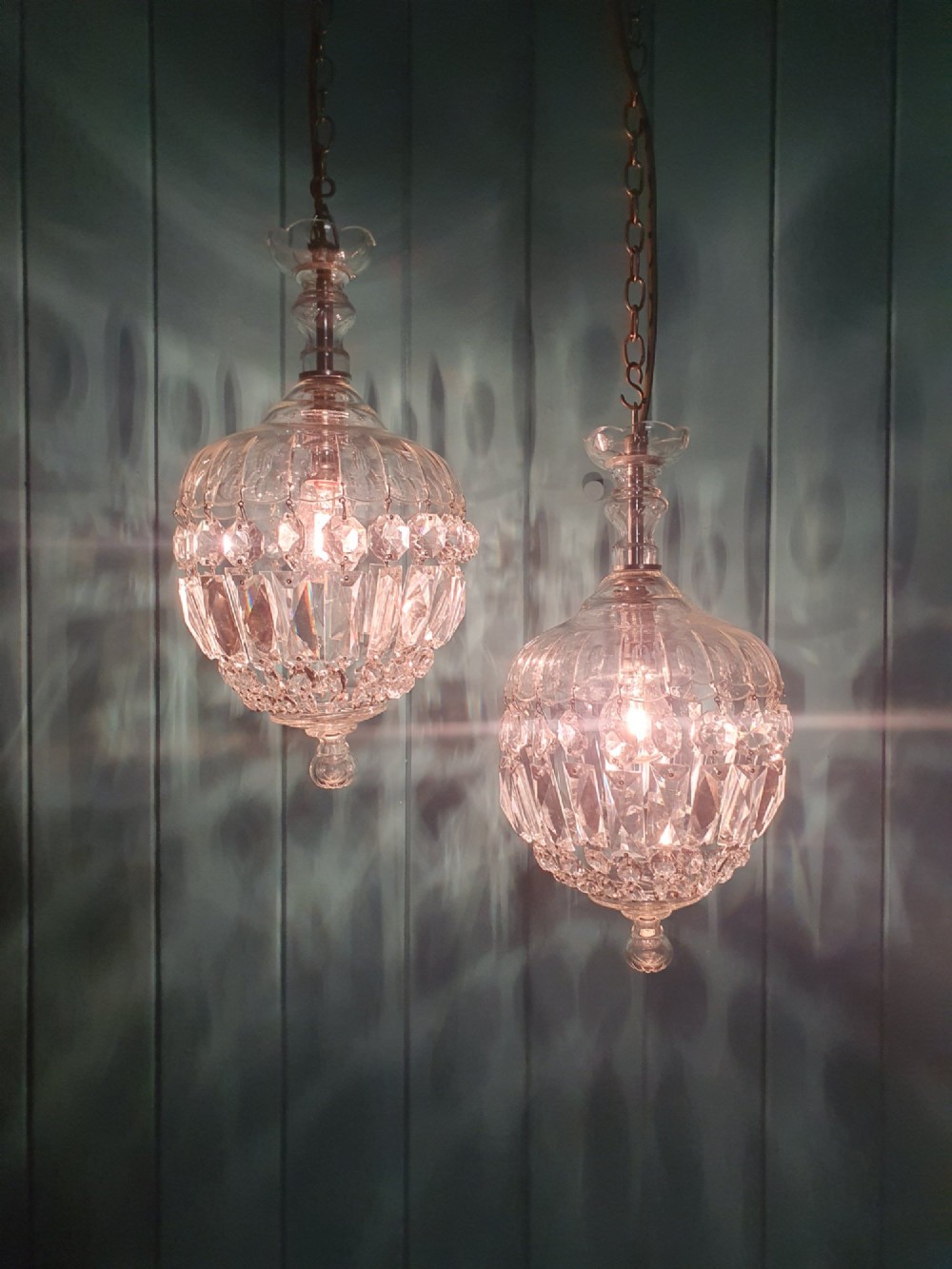A pair of early 20th-century crystal bag pendant lights featuring dome glass tops and cascading cut glass drops hanging from brass chains. View II