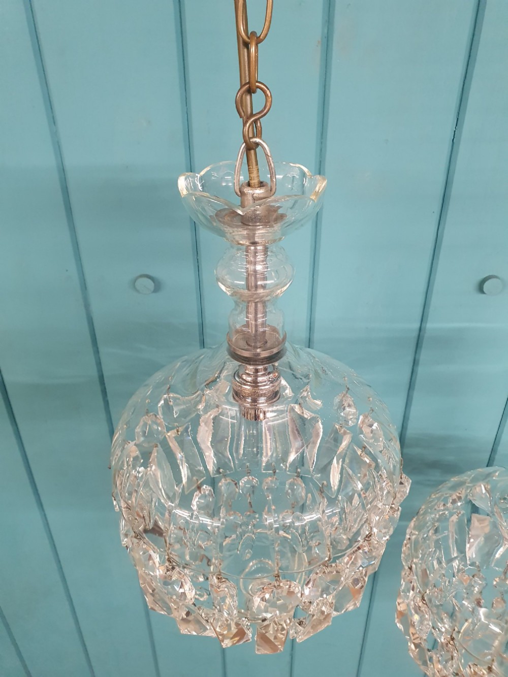 A pair of early 20th-century crystal bag pendant lights featuring dome glass tops and cascading cut glass drops hanging from brass chains. View III