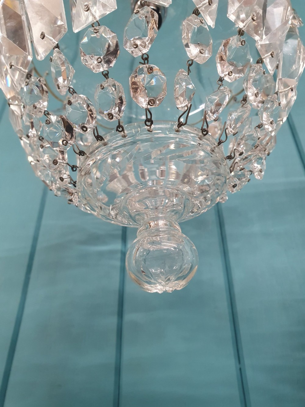 A pair of early 20th-century crystal bag pendant lights featuring dome glass tops and cascading cut glass drops hanging from brass chains. View VI