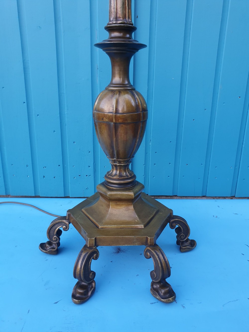 An antique bronze standard floor lamp featuring a turned baluster column, urn knop, and scrolled feet on a square stepped base. View II