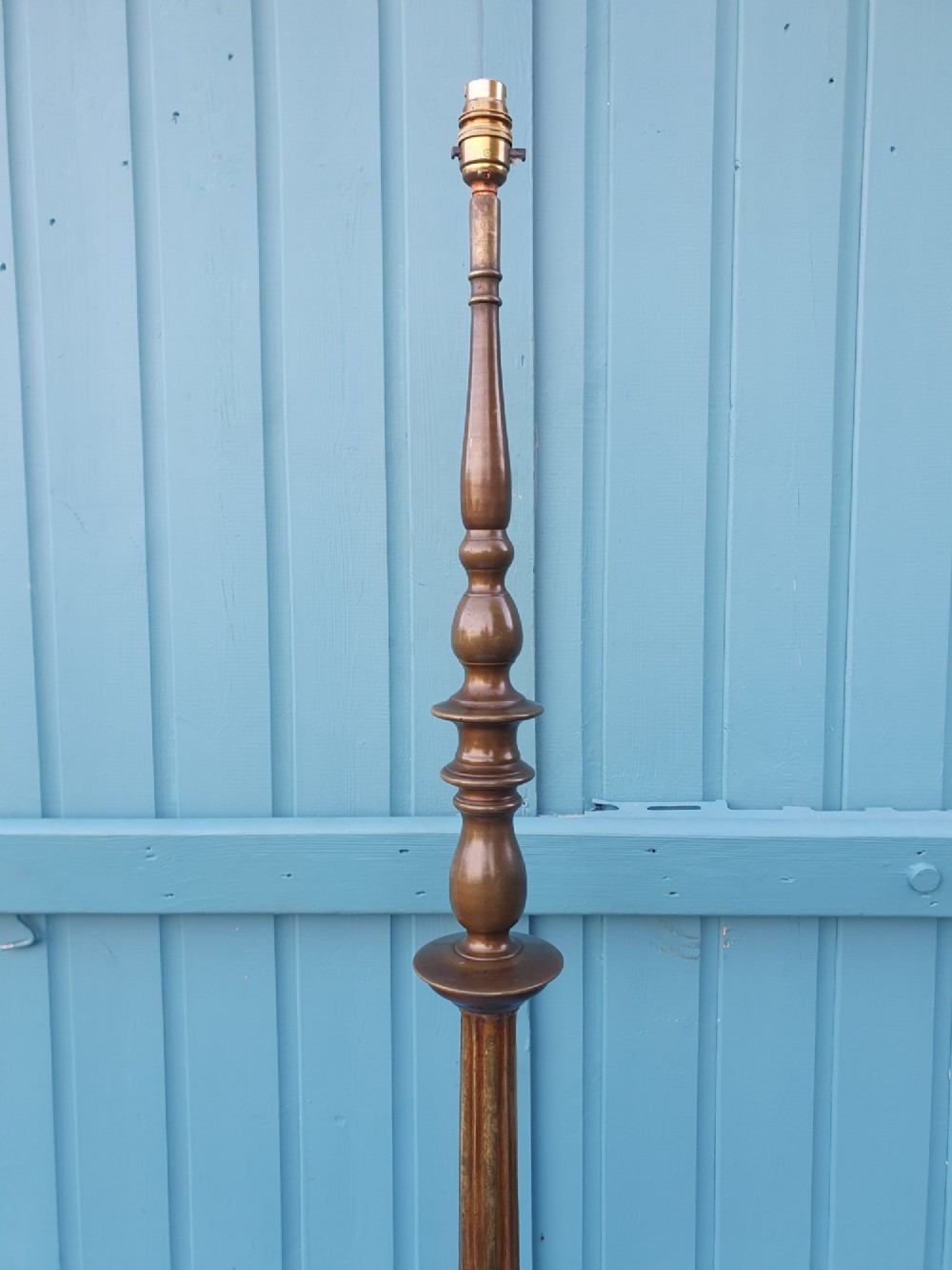 An antique bronze standard floor lamp featuring a turned baluster column, urn knop, and scrolled feet on a square stepped base. View III