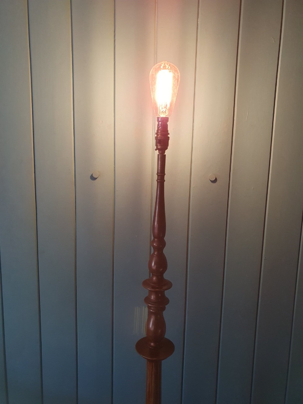 An antique bronze standard floor lamp featuring a turned baluster column, urn knop, and scrolled feet on a square stepped base. View VIII