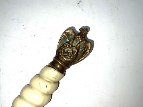 A German Kriegsmarine officer dress dagger featuring a cream wire-wrapped grip, spherical eagle pommel, crossguard, and an engraved brass scabbard with two suspension rings. View XI