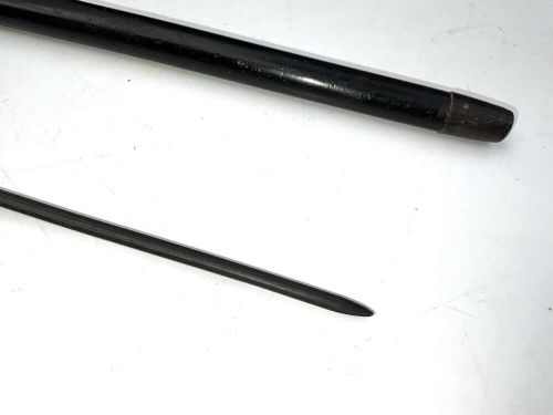 A black ebonised wooden walking stick featuring a curved crook handle, a silver-toned metal collar, and a protective tip. View VI