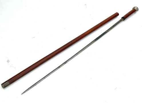 A tapered dark wooden swagger stick featuring a polished silver-toned metal pommel cap and a protective metal ferrule. View II