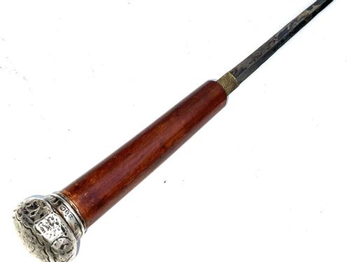 A tapered dark wooden swagger stick featuring a polished silver-toned metal pommel cap and a protective metal ferrule. View IV