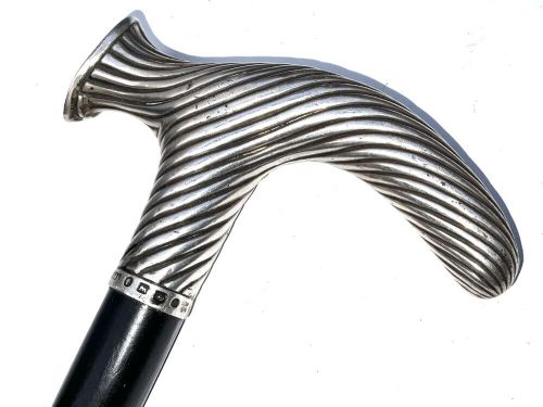 A Victorian dark wood walking cane featuring a decorative silver handle and a brass protective ferrule at the base. View III