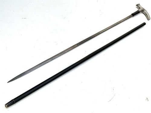 A Victorian dark wood walking cane featuring a decorative silver handle and a brass protective ferrule at the base. View V