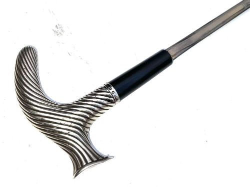 A Victorian dark wood walking cane featuring a decorative silver handle and a brass protective ferrule at the base. View VII