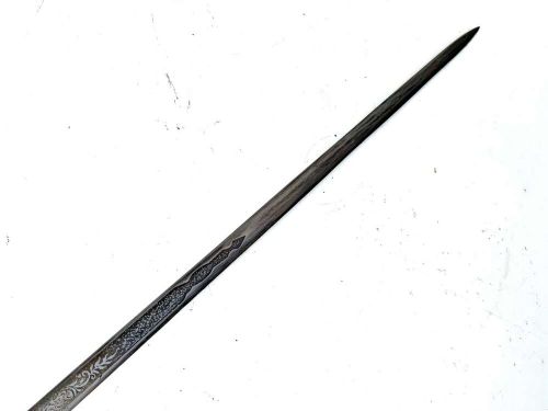 A Victorian dark wood walking cane featuring a decorative silver handle and a brass protective ferrule at the base. View X