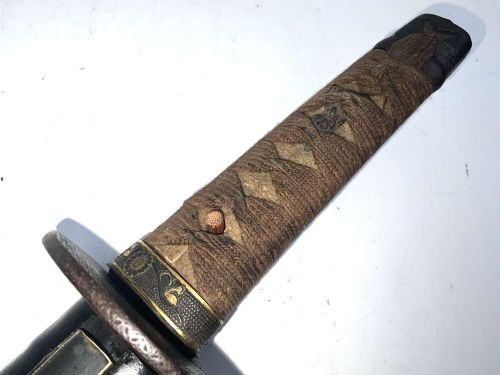 An 18th-century Japanese Wakizashi samurai sword featuring a textured black lacquered scabbard, round iron tsuba, and wrapped handle. View II