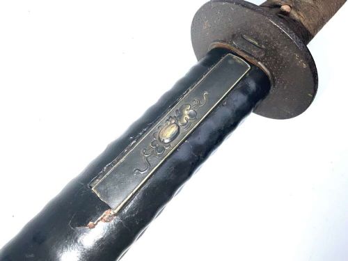 An 18th-century Japanese Wakizashi samurai sword featuring a textured black lacquered scabbard, round iron tsuba, and wrapped handle. View III