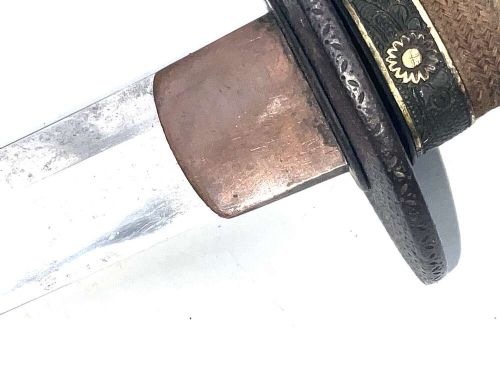 An 18th-century Japanese Wakizashi samurai sword featuring a textured black lacquered scabbard, round iron tsuba, and wrapped handle. View X