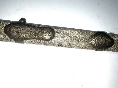 A Chinese double-edged Jian sword resting inside a detailed metal-mounted scabbard. View IV