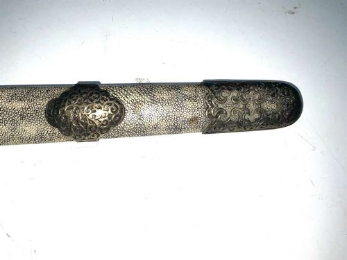 A Chinese double-edged Jian sword resting inside a detailed metal-mounted scabbard. View V