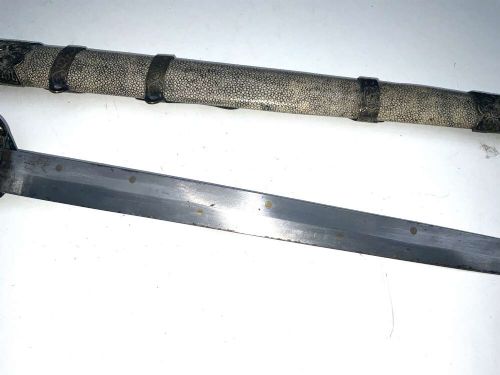 A Chinese double-edged Jian sword resting inside a detailed metal-mounted scabbard. View VIII