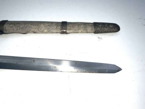 A Chinese double-edged Jian sword resting inside a detailed metal-mounted scabbard. View IX