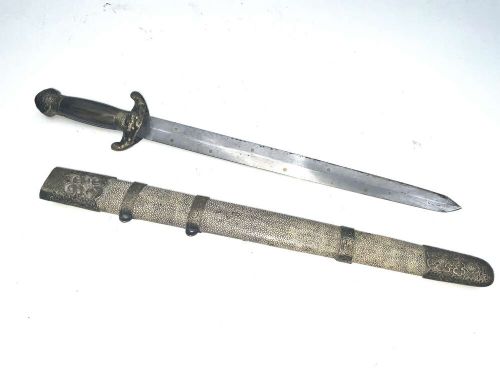 A Chinese double-edged Jian sword resting inside a detailed metal-mounted scabbard. View X