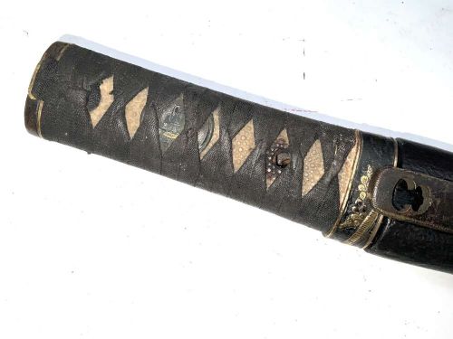 An Edo period Japanese samurai tanto dagger enclosed in a black lacquered wood scabbard with a wrapped handle. View II