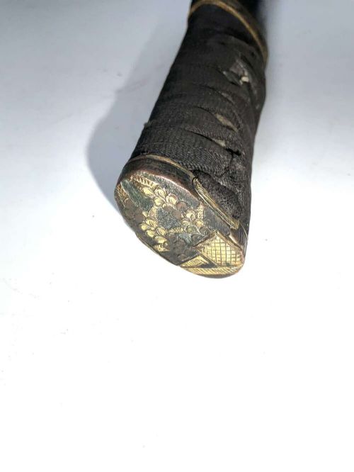 An Edo period Japanese samurai tanto dagger enclosed in a black lacquered wood scabbard with a wrapped handle. View VII