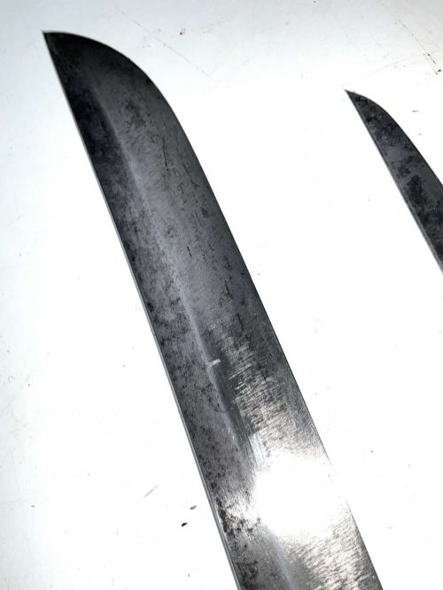 An Edo period Japanese samurai tanto dagger enclosed in a black lacquered wood scabbard with a wrapped handle. View IX