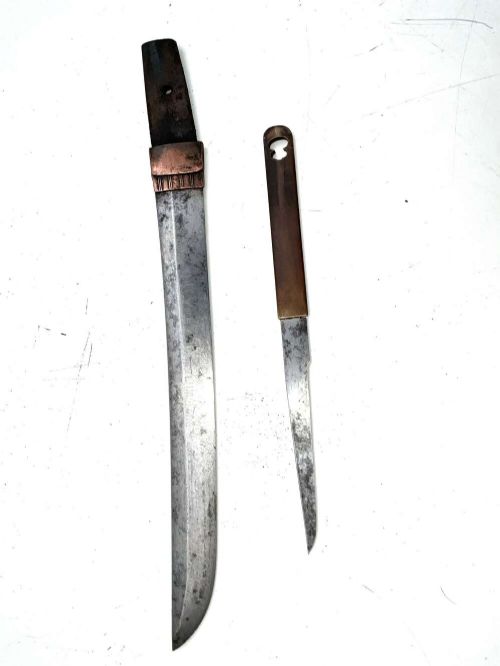 An Edo period Japanese samurai tanto dagger enclosed in a black lacquered wood scabbard with a wrapped handle. View X