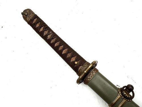 A Second World War Japanese officer sword in an olive green metal scabbard with brass fittings and a bound handle. View II