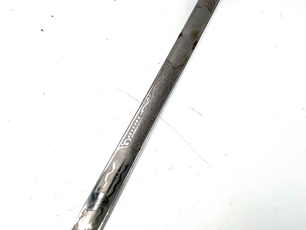 An 18th-century rapier sword featuring a dark leather scabbard and an intricately pierced round steel hilt guard. View IV