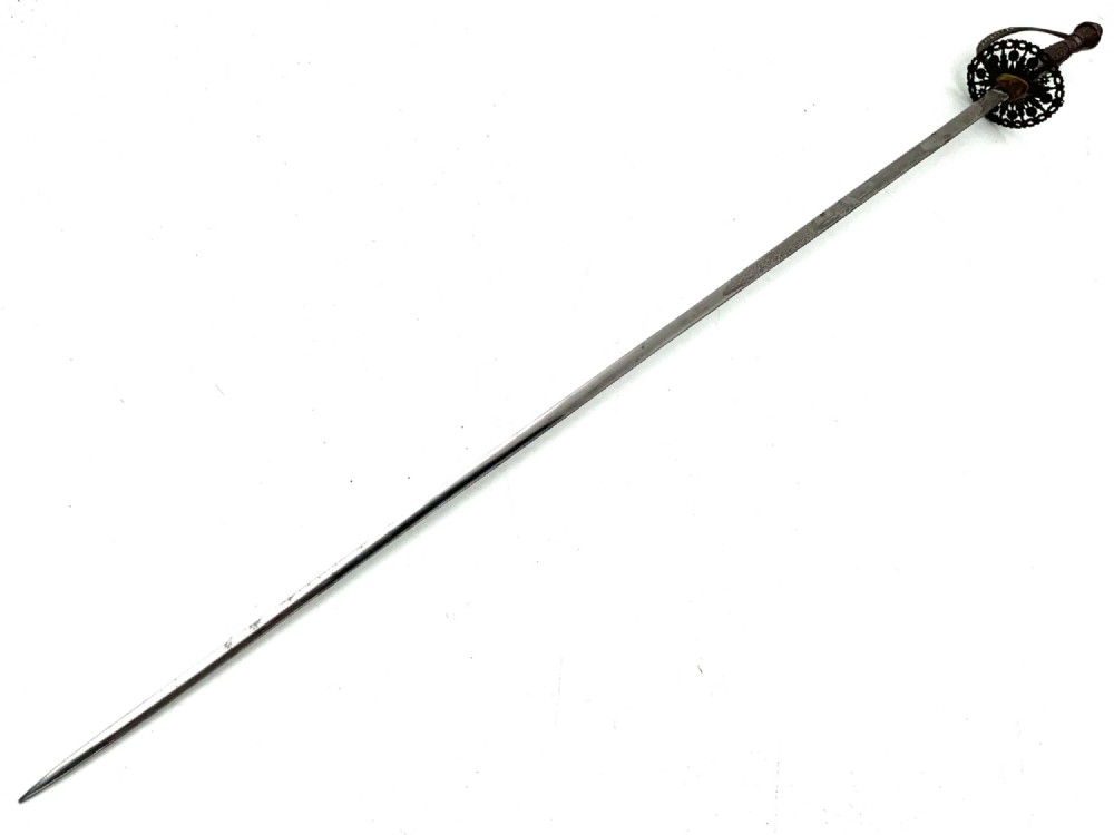 An 18th-century rapier sword featuring a dark leather scabbard and an intricately pierced round steel hilt guard. View X