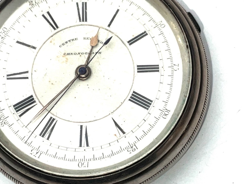 An antique silver open-face pocket watch featuring a white enamel dial with Roman numerals, centre seconds chronograph markings, and an attached top suspension loop. View II