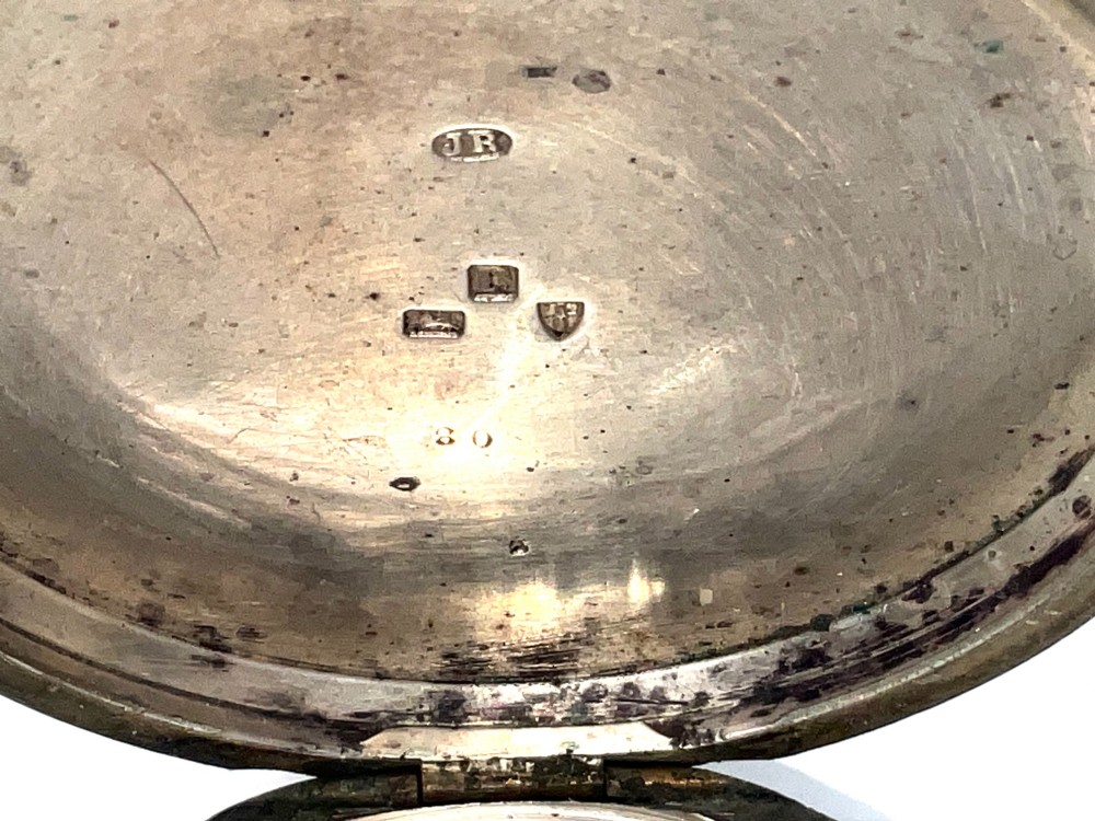An antique silver open-face pocket watch featuring a white enamel dial with Roman numerals, centre seconds chronograph markings, and an attached top suspension loop. View V