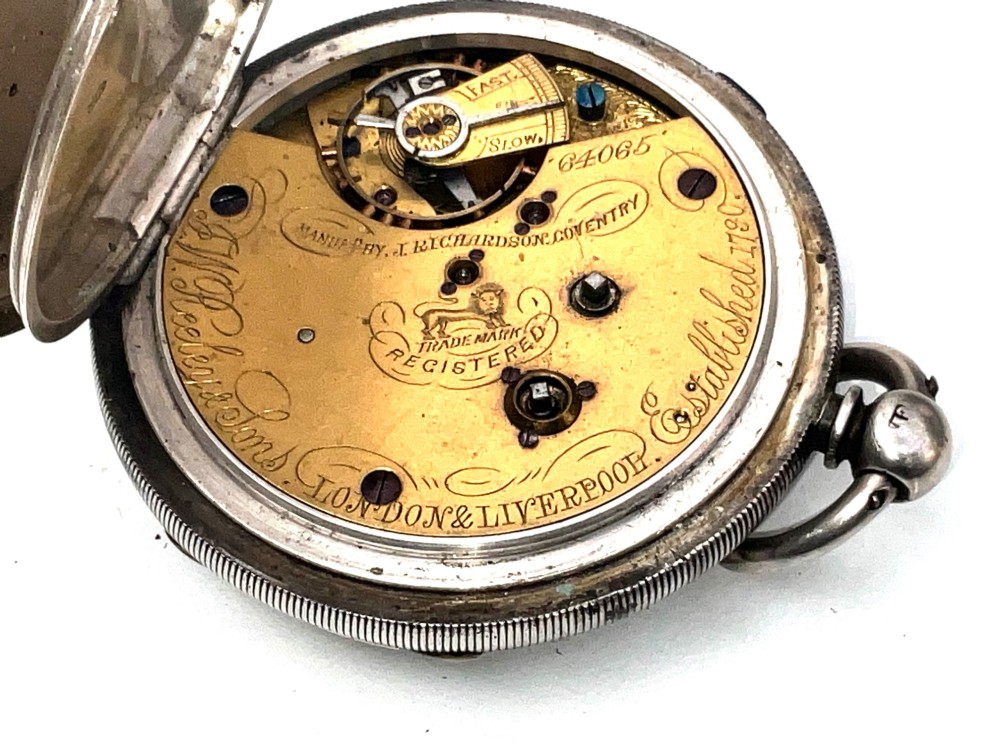 An antique silver open-face pocket watch featuring a white enamel dial with Roman numerals, centre seconds chronograph markings, and an attached top suspension loop. View IX